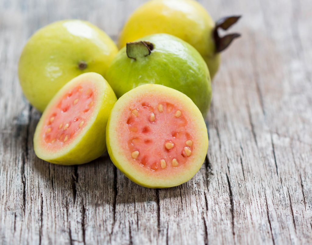 48174650 - fresh guava fruit on wooden table.