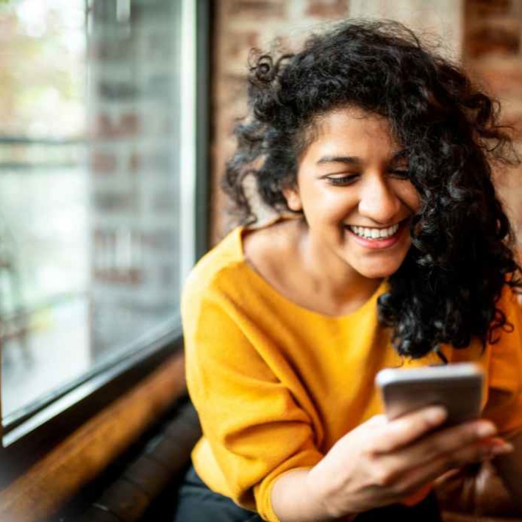 Girl smiling with phone in hand