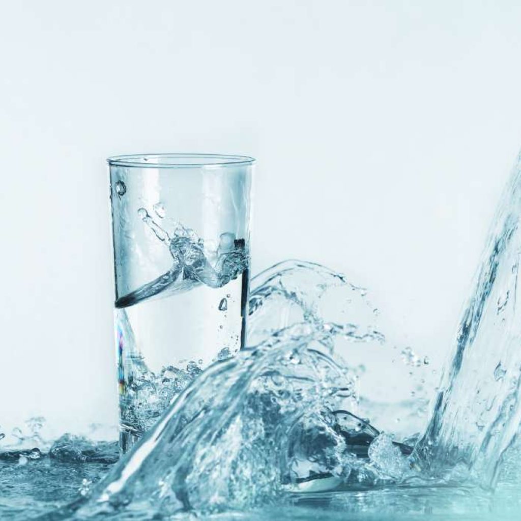 Water splashing around a glass of water