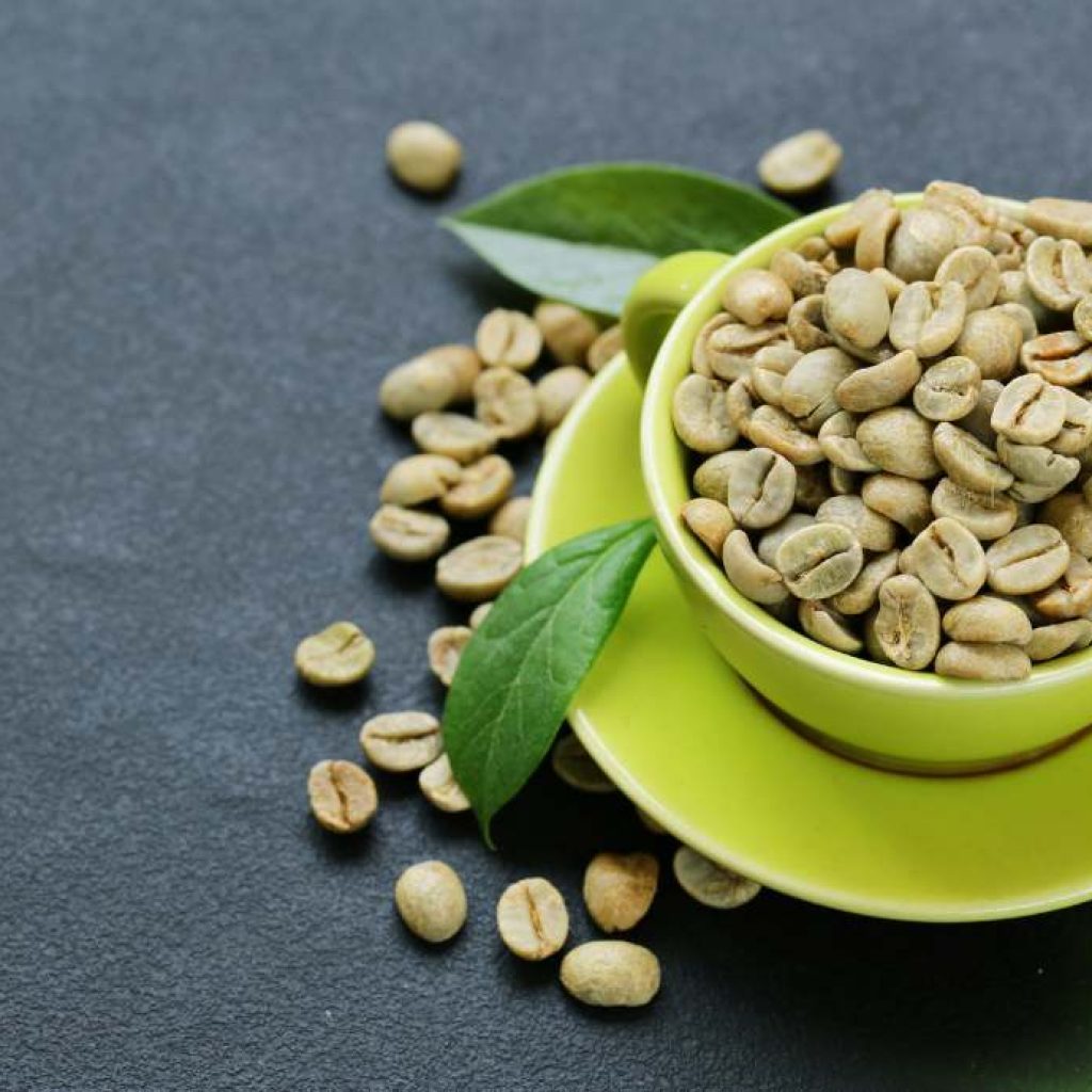 green coffee beans in a green mug