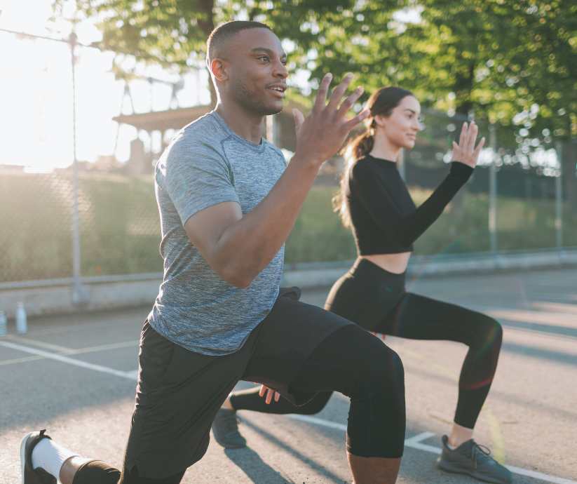 Man and woman lunging together for exercise