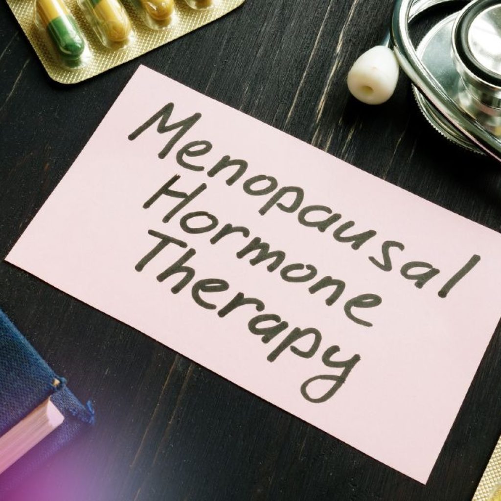 Menopausal Hormone Therapy written on a piece of paper with medication on table