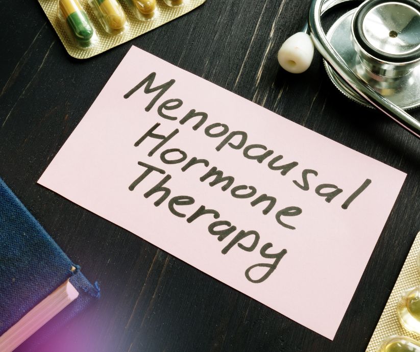 Menopausal Hormone Therapy written on a piece of paper with medication on table